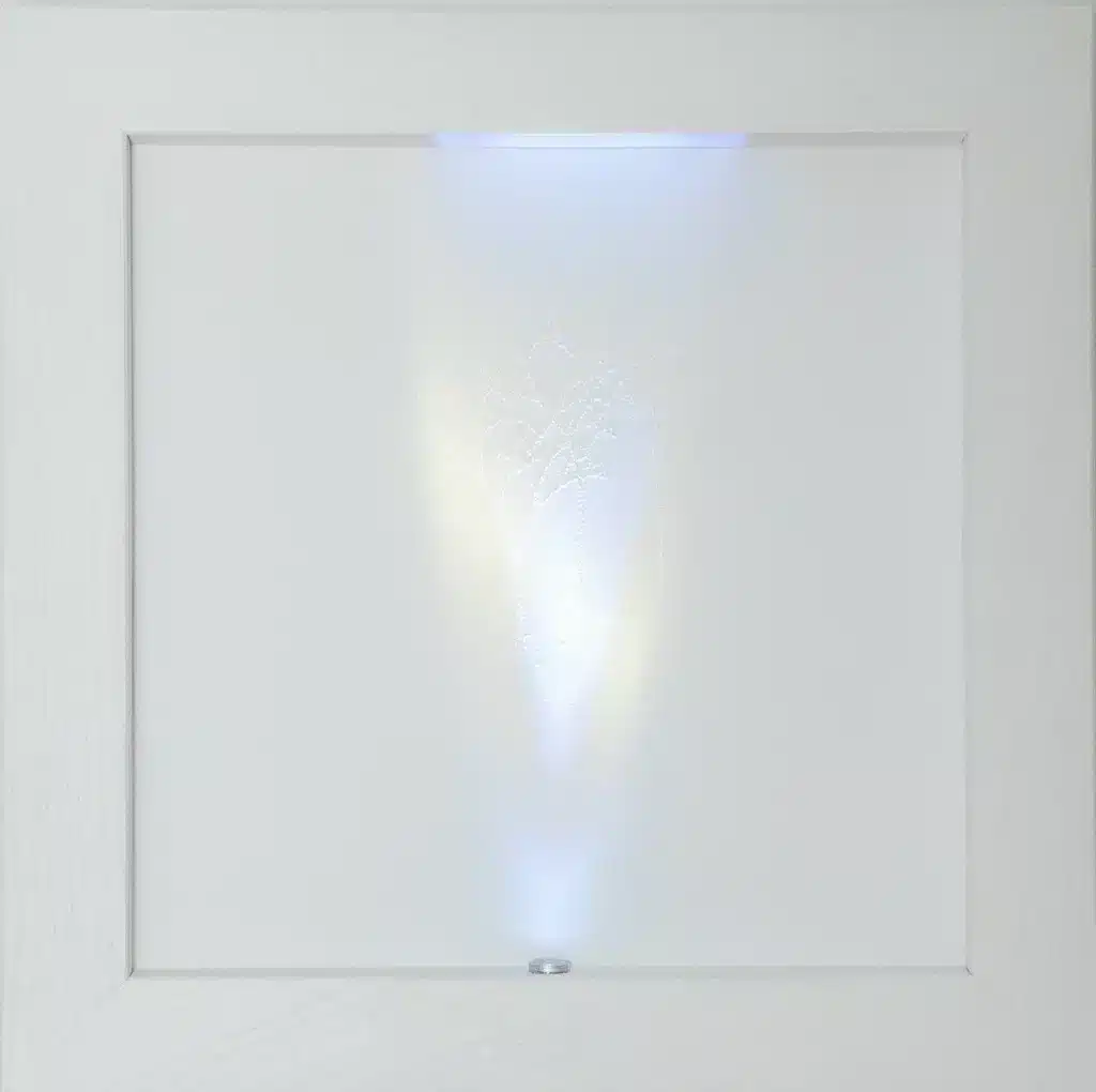 “Fractals. Conversation” 2025, tecnica mista su carta cotone forata, led, legno e vetro / mixed media on perforated cotton paper, led, wood and glass – cm. 38 x 38 x 7