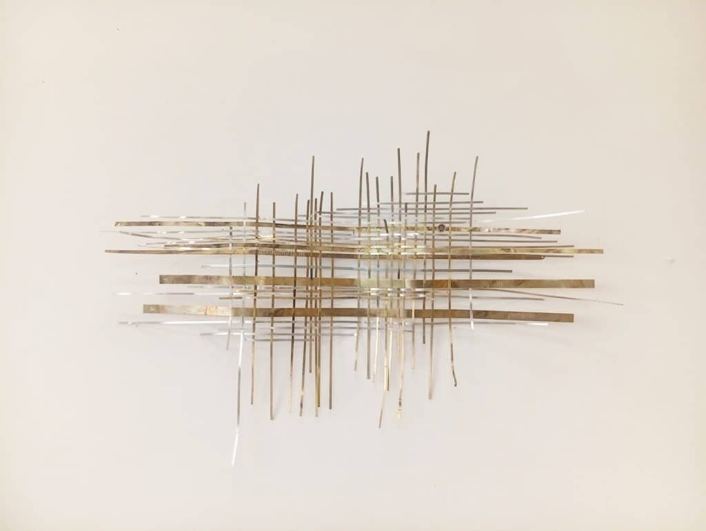 “Interlaces. Helleborum” 2026, plants imprints on interwoven metals, brass capsule
with leaf and seeds of Helleborum